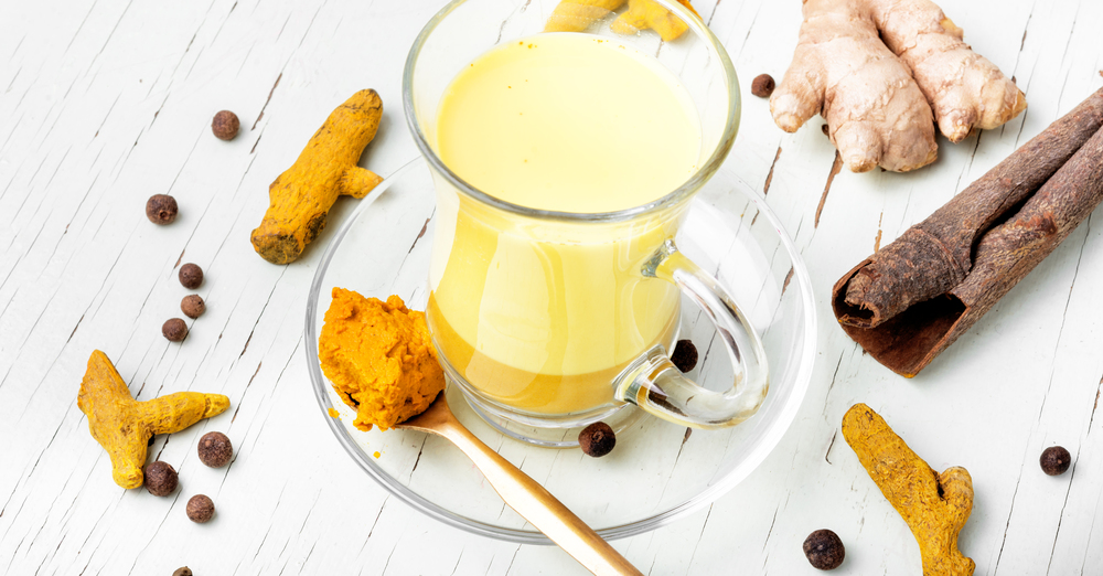 Healthy golden milk. Golden remedy milk with turmeric,ginger,pepper and cinnamon
