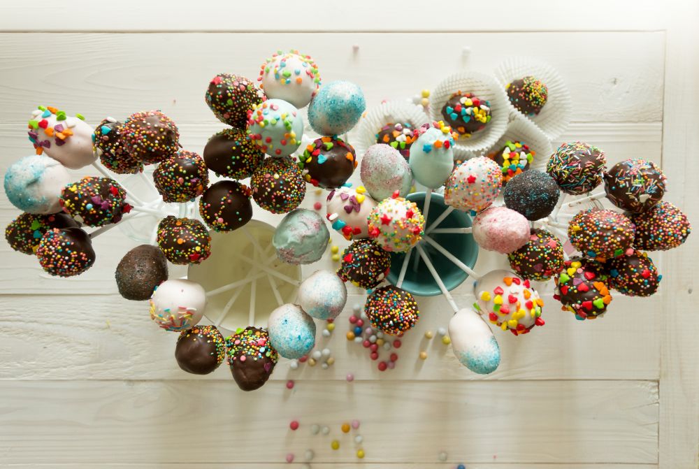 View from top on beautiful colorful cake pops on wooden table