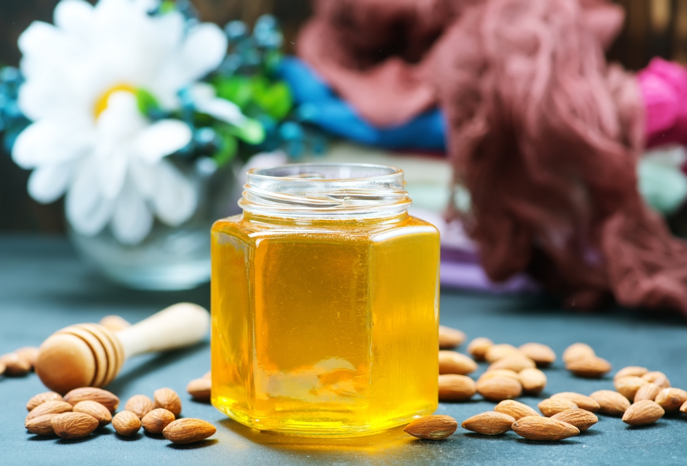 honey with nuts on a table, stock photo