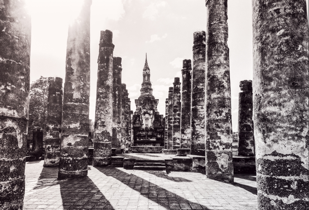 Black and white two tone vintage style, Ancient chapel among the ruins pillars under the bright sun at Wat Maha That temple in Sukhothai Historical Park landmark of Sukhothai Province, Thailand