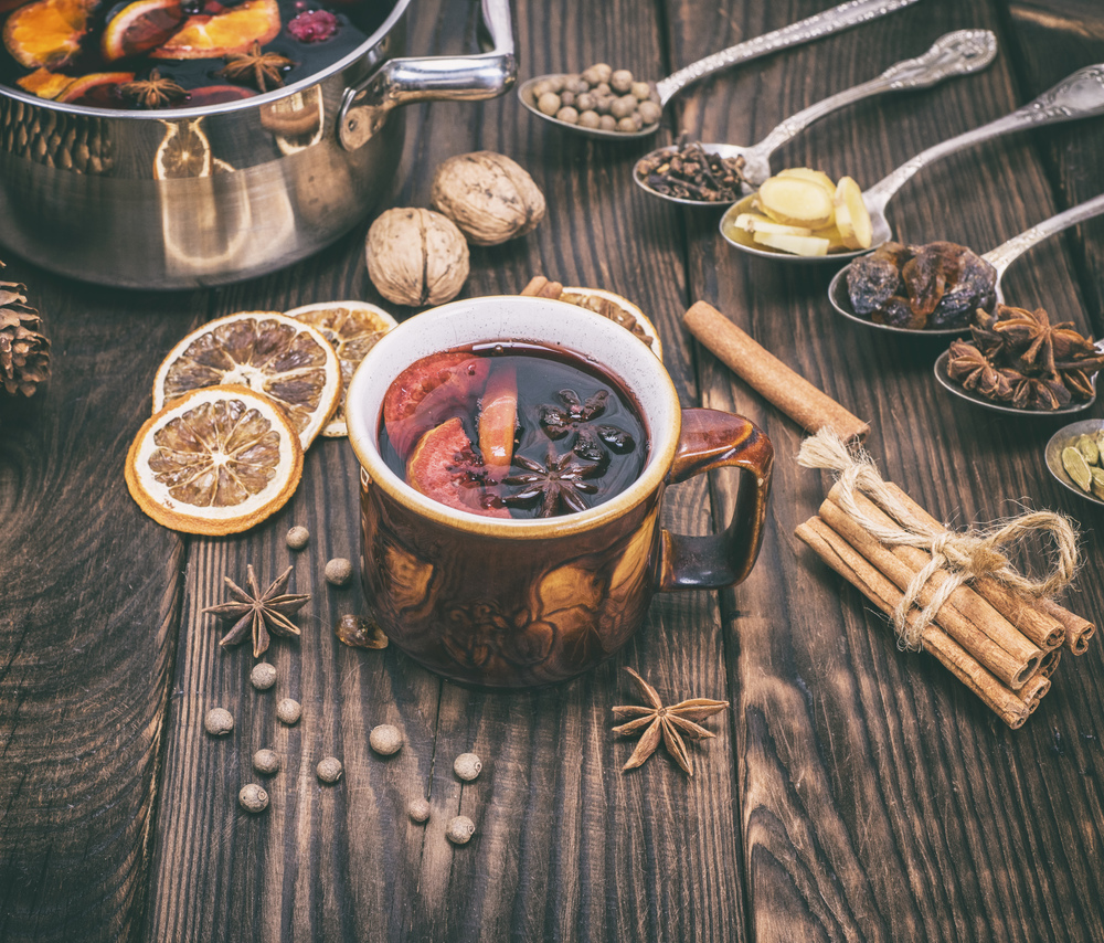 mulled wine in a brown cup and ingredients for making a drink, vintage toning