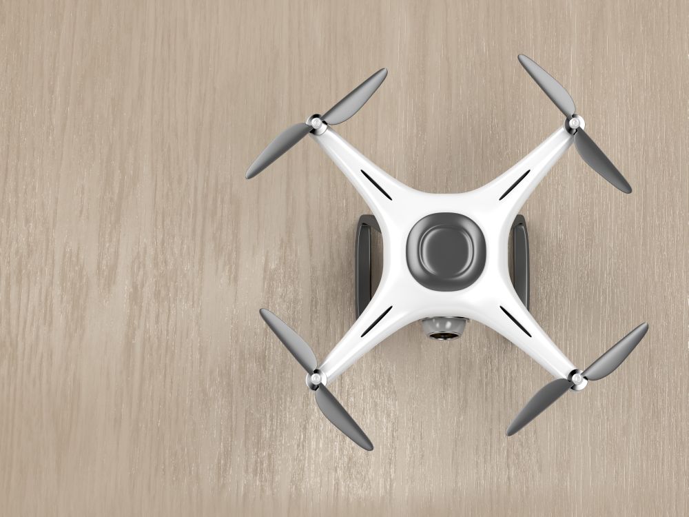 Unmanned aerial vehicle on wood background, top view