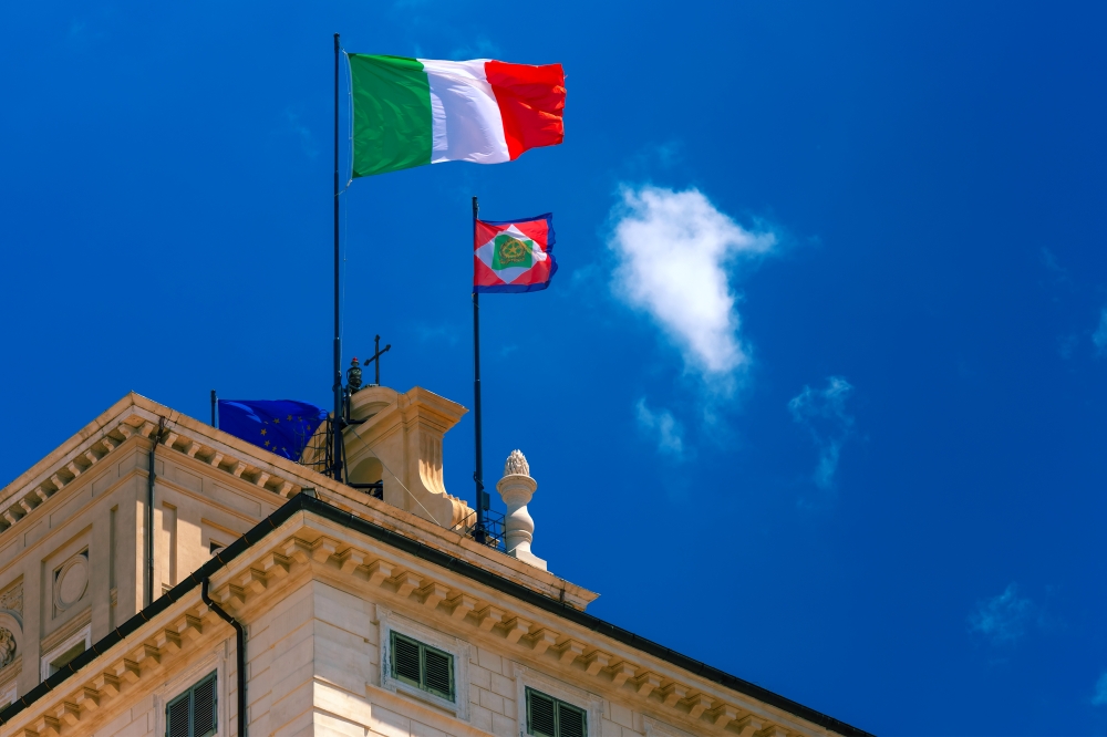 Italian flag and Presidential pennant, Rome, Italy. Beautiful large waving the flag of Italy and Italian Presidential pennant over Quirinal Palace against the blue sky, Rome, Italy.