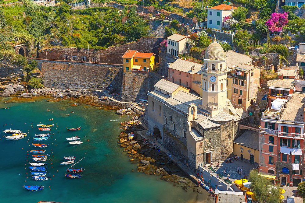 Aerial view with colorful fishing boats and Santa Margherita di Antiochia Church in Vernazza harbour in Five lands, Cinque Terre National Park, Liguria, Italy.
