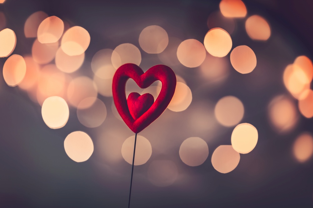 Beautiful red heart over blurry vintage bokeh background, romantic greeting card for Valentine&rsquo;s day, love concept