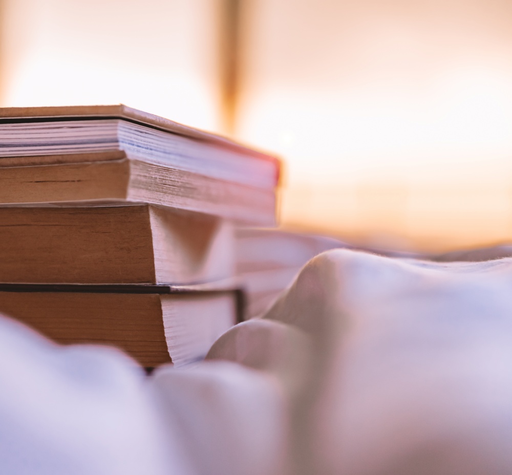 A Stack of Several Books Lies on the Bed at Home. Enjoying Reading Wonderful Books in Leisure Time. Great Relaxing Hobby.. Reading Books at Home