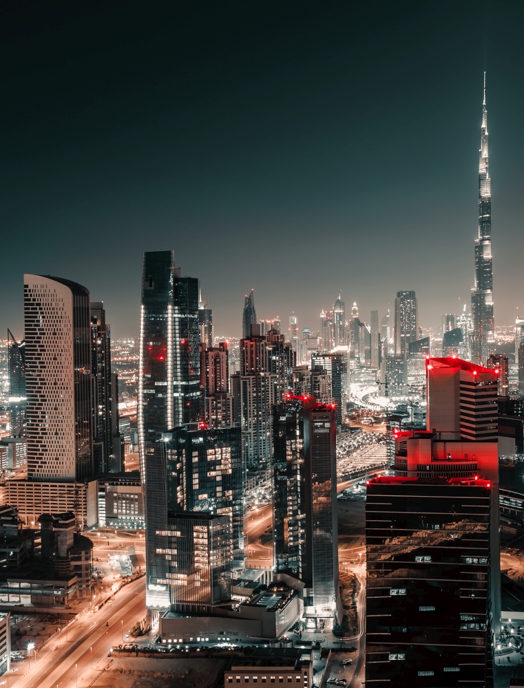 Nighttime Cityscape. Urban Scene Background of a Modern Towers at Night. Lights of Big City. Dubai. United Arab Emirates.