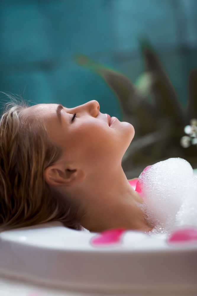 Closeup profile portrait of a beautiful girl enjoying day at spa salon, taking bath with foam, luxury lifestyle and wellness concept