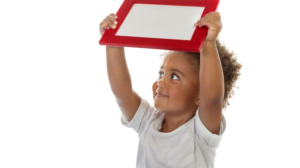 Portrait of a Cute Little African American Boy with Red Frame in Hands. Isolated on White Background. Photo with Copy Space. Preschool Education. Back to School Concept.