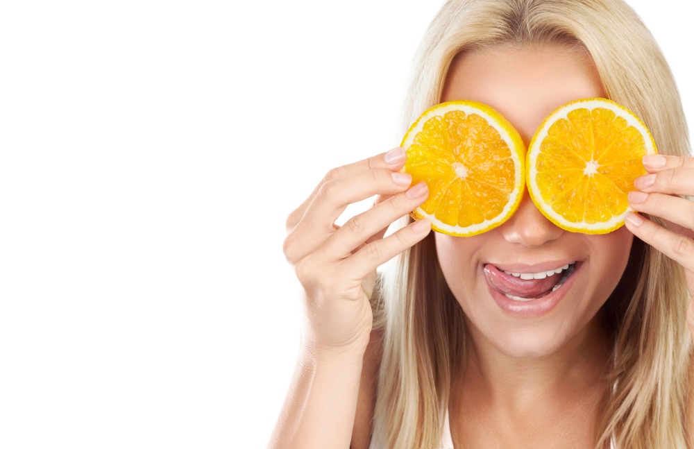 Portrait of nice funny girl covering her eyes with orange slices and making fun faces, isolated on white background, vitamin C, happy healthy lifestyle