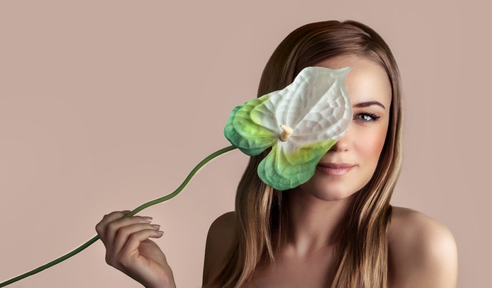 Perfect skin therapy, body and beauty natural care, portrait of a pretty woman with calla flower isolated on beige pink pastel background, enjoying spa, healthy organic herbal treatment