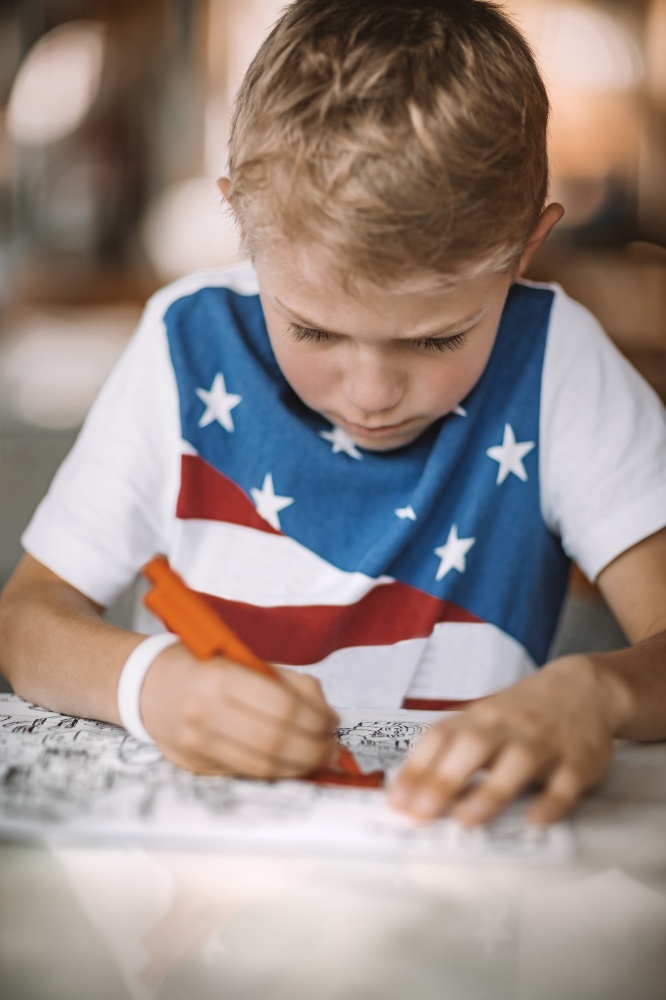 Portrait of a Serious Boy with Concentration Drawing and Coloring. Children on Distance Education. Homework or Leisure Time. Schooling at Home.