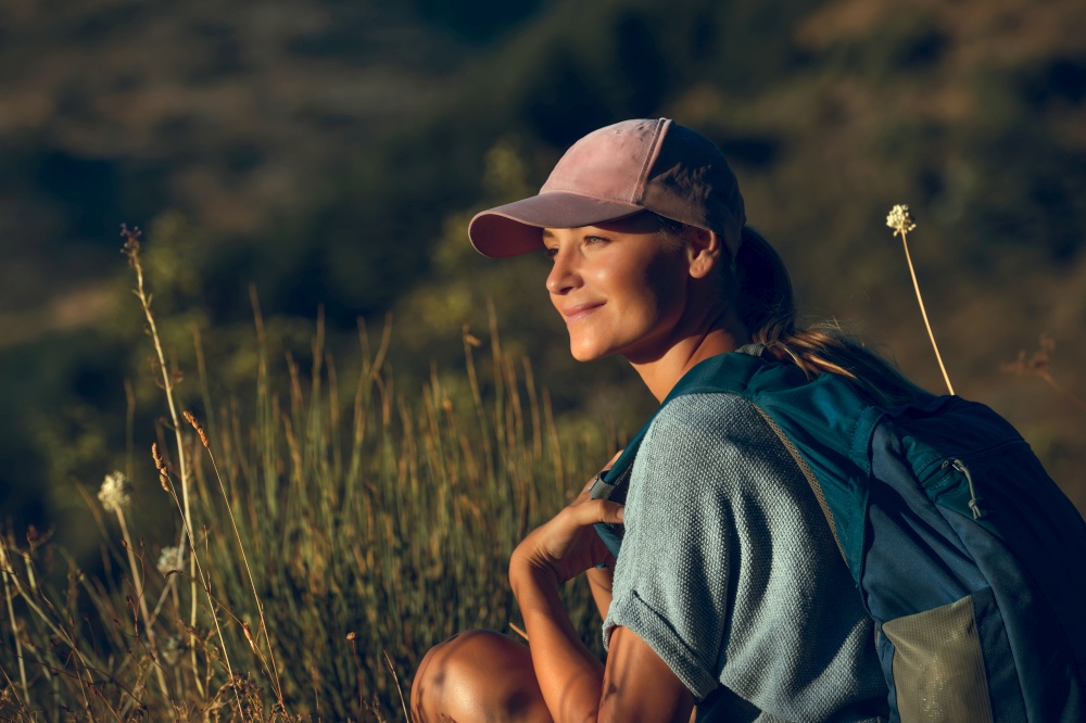 Portrait of a Beautiful Happy Woman Enjoying Mild Sunset Light in the Mountains. Beauty of Wild Nature. Peaceful Quiet Weekend Outdoors.