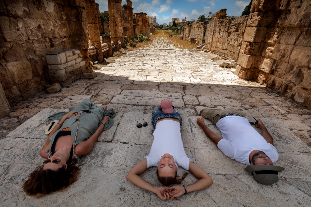 Best Friends Spending Day in the Ruins of Tyre. Resting after Excursion along Necropolis in Lebanon. Touristic Place. World Heritage. Active People Taveling. Summer Vacation.
