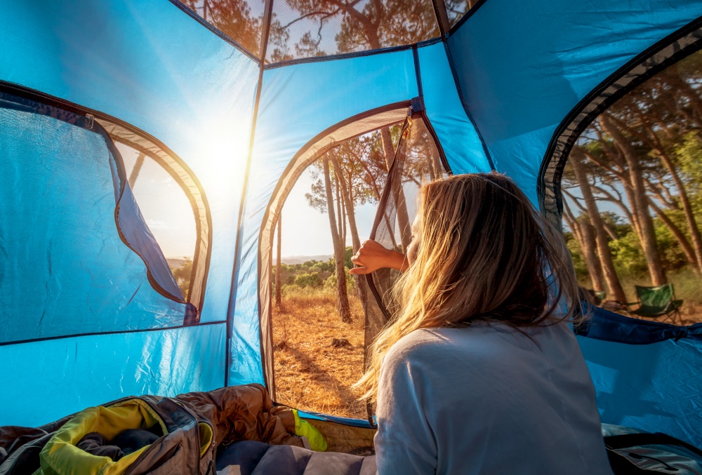 Morning in the Tent, Young Woman Woke up and Looks out at the Amazing Beauty of Nature. Enjoying Camping in the Mountainous Forest. Active Summer Holidays.