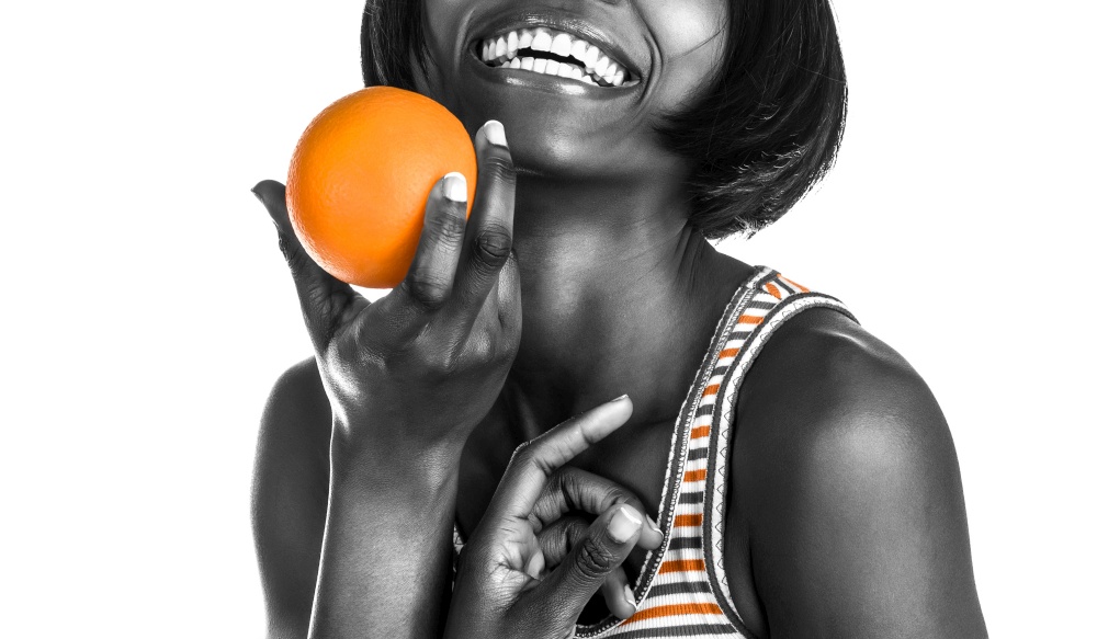 Portrait of a Happy Cheerful African American Woman. Healthy Food. Isolated on White Background. Dental Care. Black Female With Perfect White Teeth.