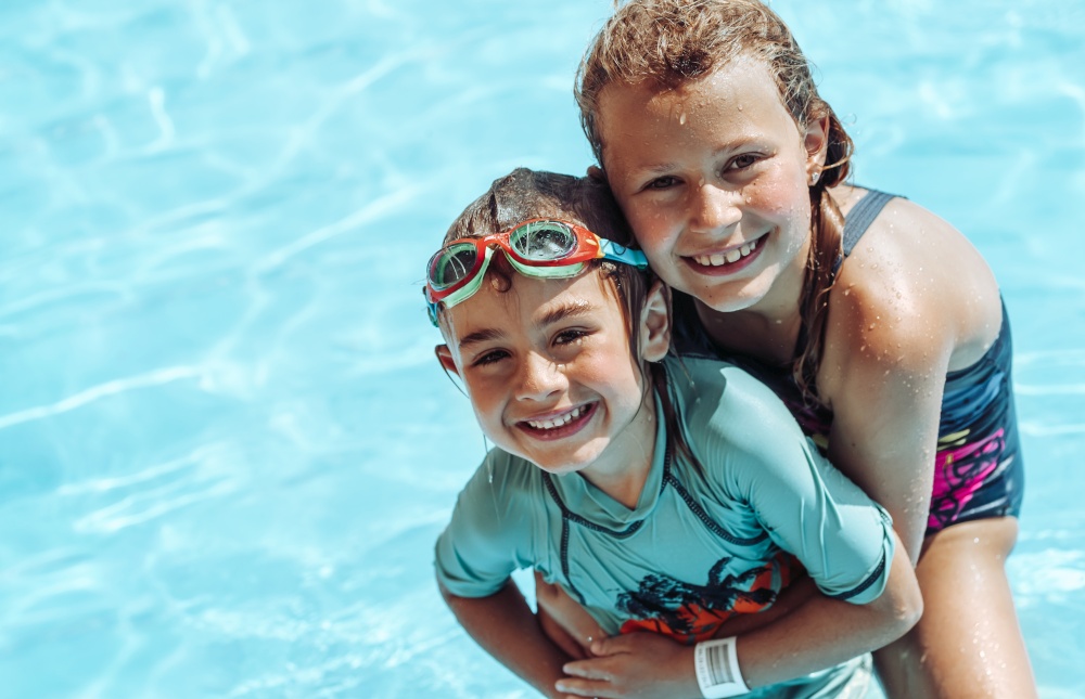 Portrait of a Cute Kids Having Fun in the Pool. Sweet Siblings Spending Time Together on the Beach. Happy Vacation on the Beach Resort.. Happy Kids in the Pool