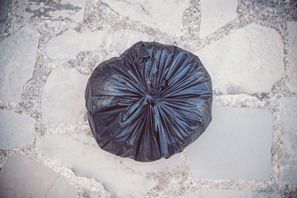 Photo of Sorted Garbage in the Plastic Biodegradable Bag. Black Trash Bag onthe Floor. Recycle to Save the Planet from Waste and Pollution. Black Garbage Bag