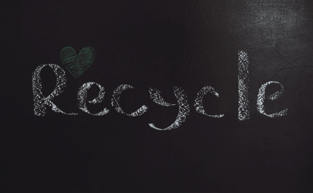 Conceptual Photo of an Environmental Protection. Garbage Recycling. Black Background with Written Word and Little Drawn Green Heart. Save the Planet Earth.. Garbage Recycling Concept