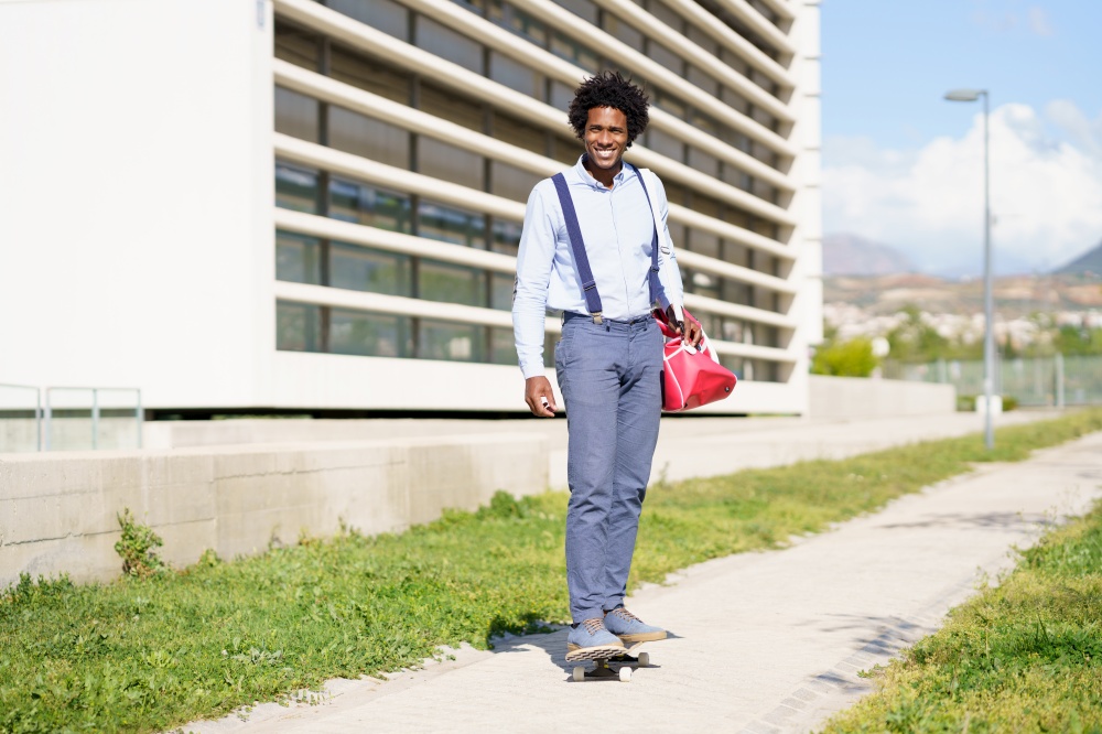 Black businessman riding skateboard near office building. Guy with afro hair.. Black businessman riding skateboard near office building.