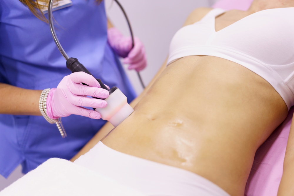 Middle-aged woman receiving anti-cellulite treatment with radiofrequency machine in an aesthetic clinic.. Woman receiving anti-cellulite treatment with radiofrequency machine in a beauty center.