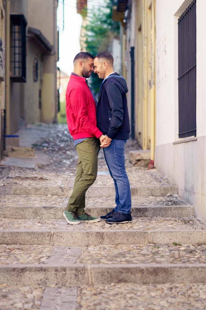Gay couple in a romantic moment in the street. Lifestyle concept.. Gay couple in a romantic moment in the street.