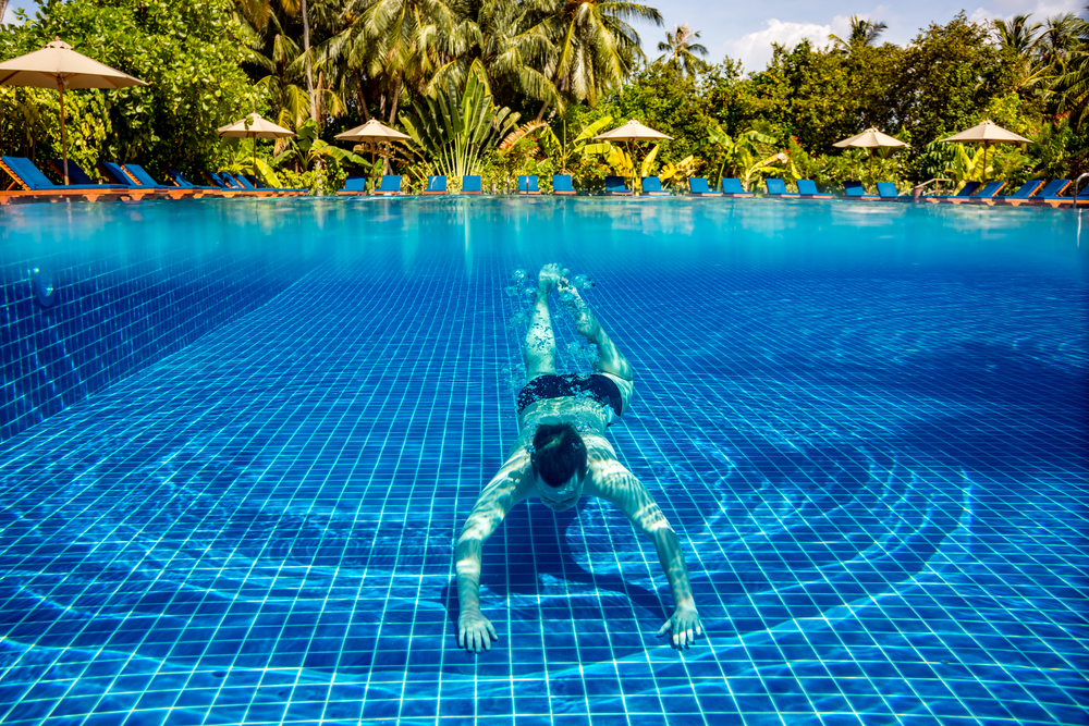 Persons under water in a swimming pool