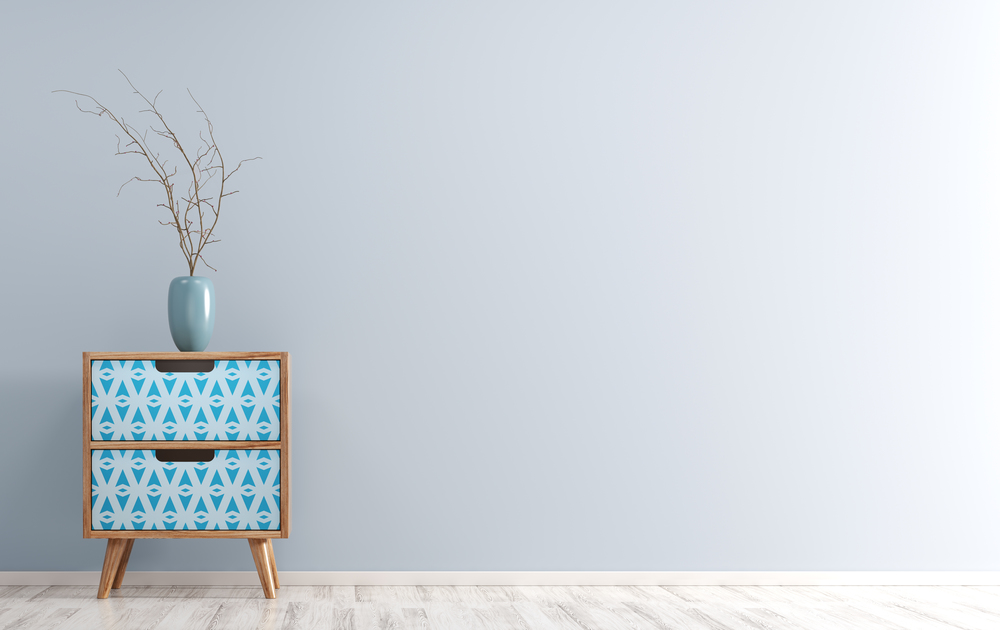 Interior background of living room with wooden side table and vase with branch on it over blue wall 3d render