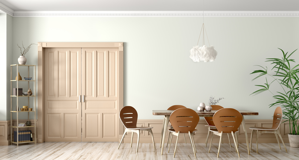 Interior of modern dining room,wooden table and chairs against wall with door 3d rendering