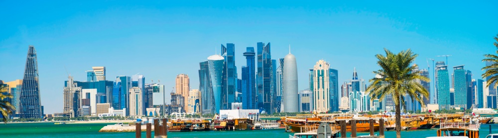 Cityscape of Doha panorama with skyscrapers of West Bay downtown district, gulf and Al Corniche road traffic. Doha, Qatar
