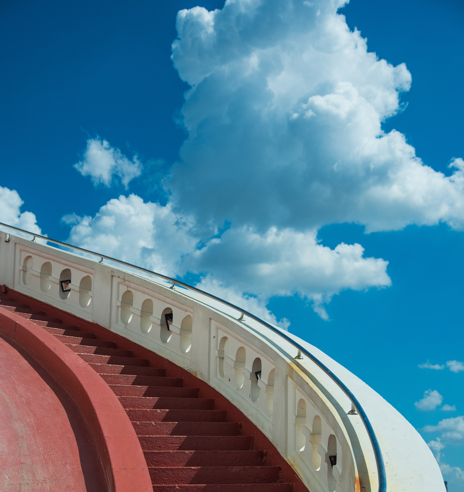 Stairs towards blue sky with white clouds