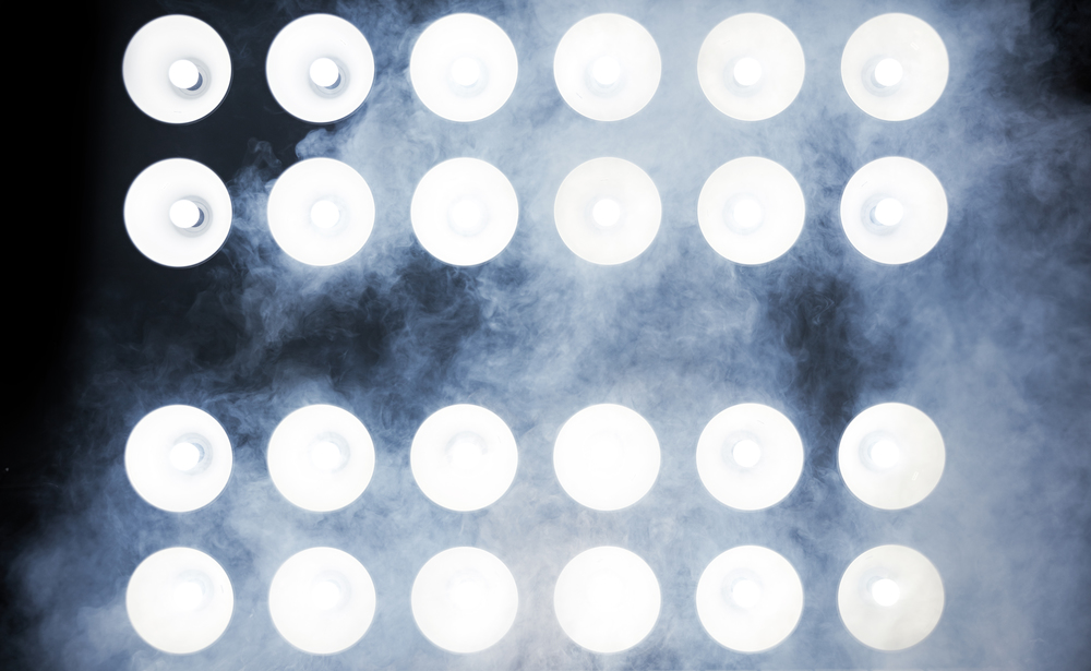 Image of powerful spotlights on a concert stage