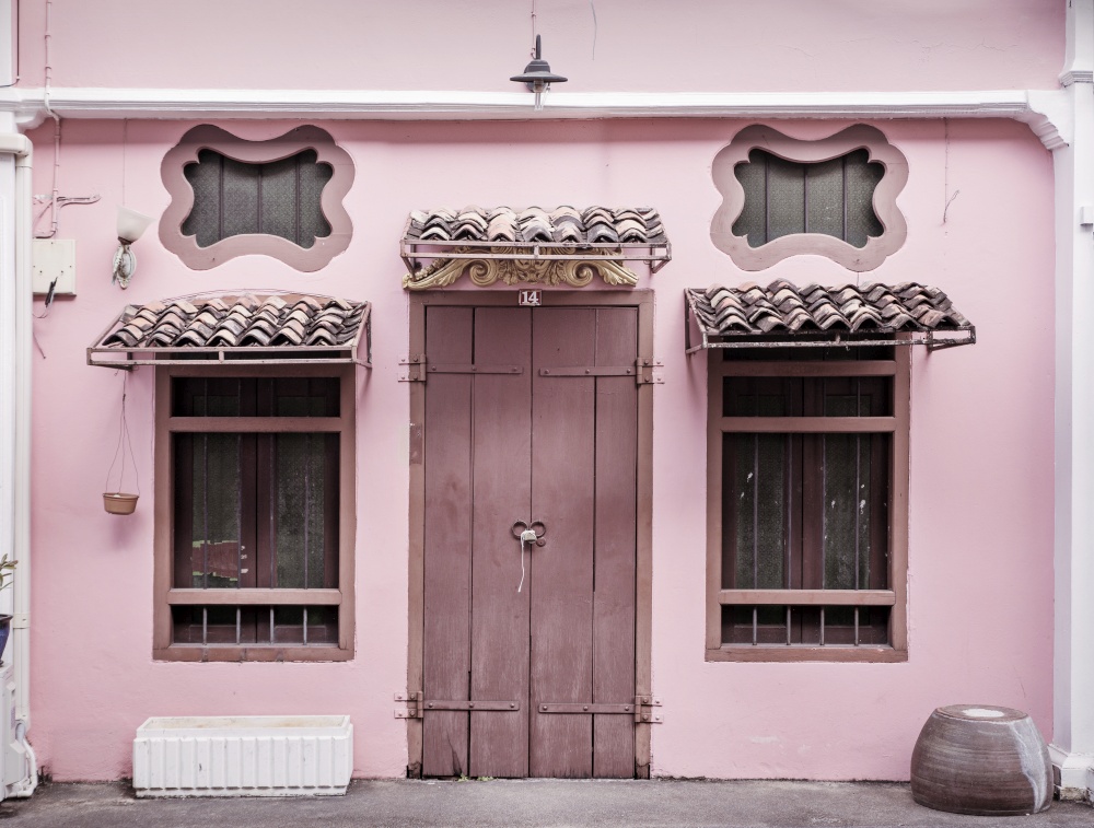 Ancient, pink building with a wooden, heavy door
