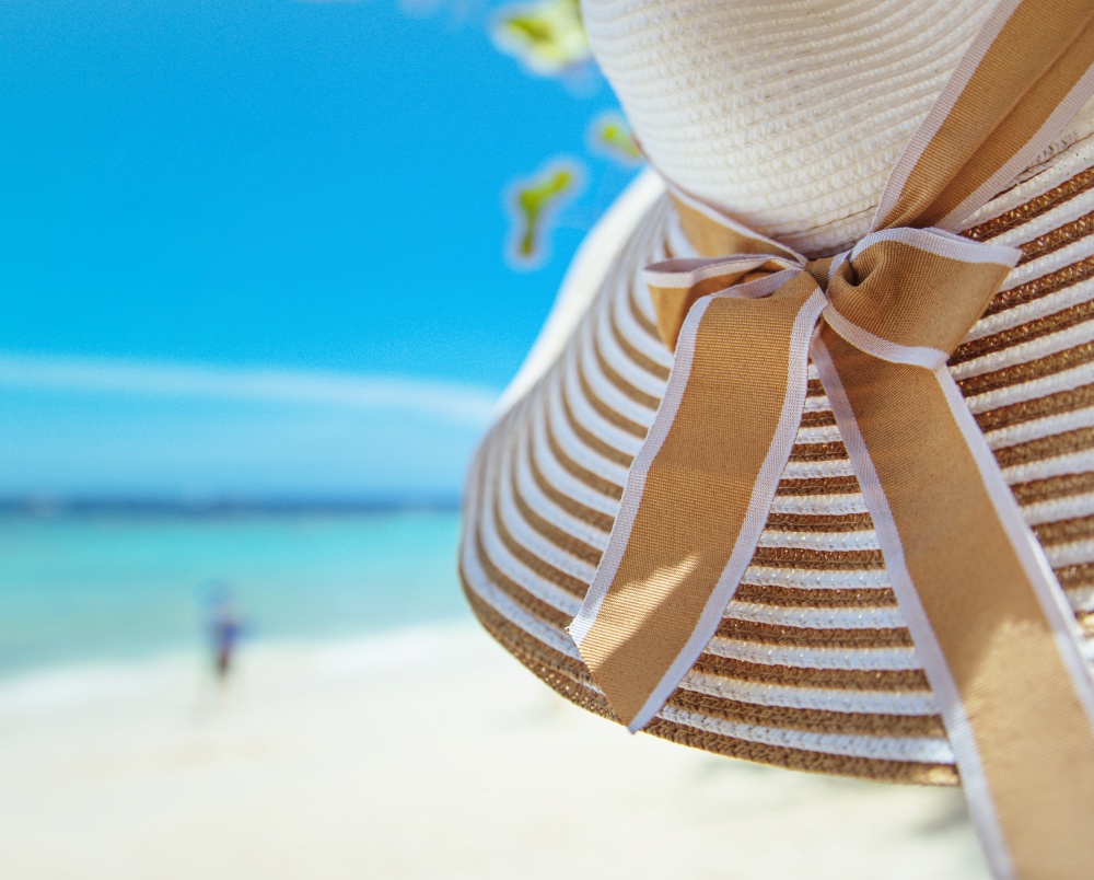 Summer accessories - straw hat, white beach, exotic view