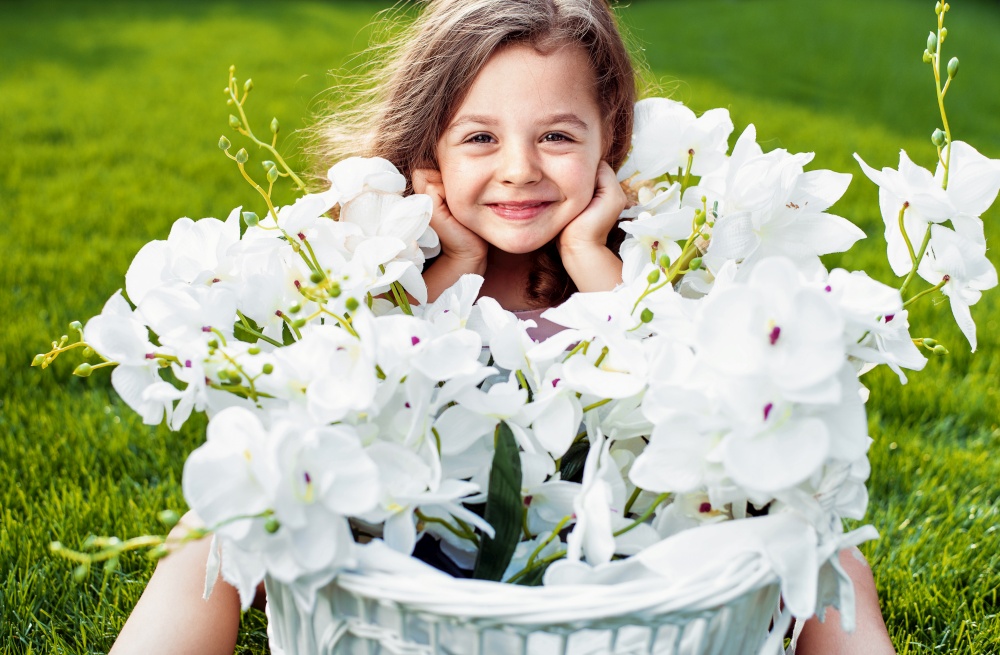Portrait of a cute smiling girl with a flower basket