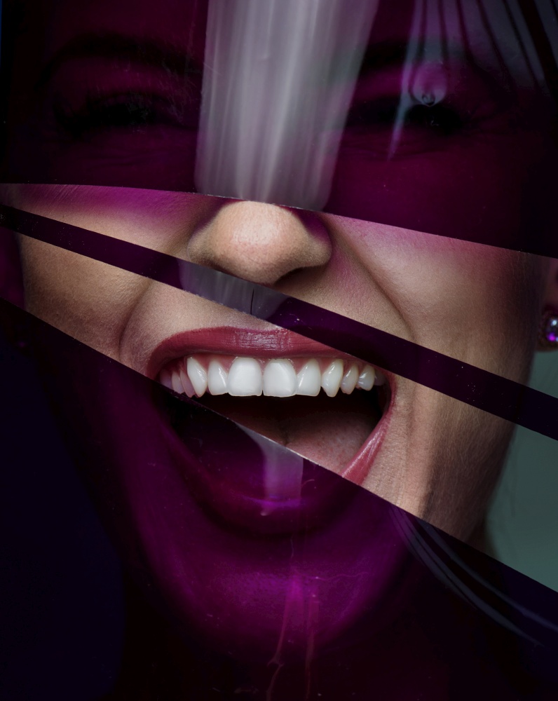 Closeup portrait of a pretty woman posing with a plastic, purple tape