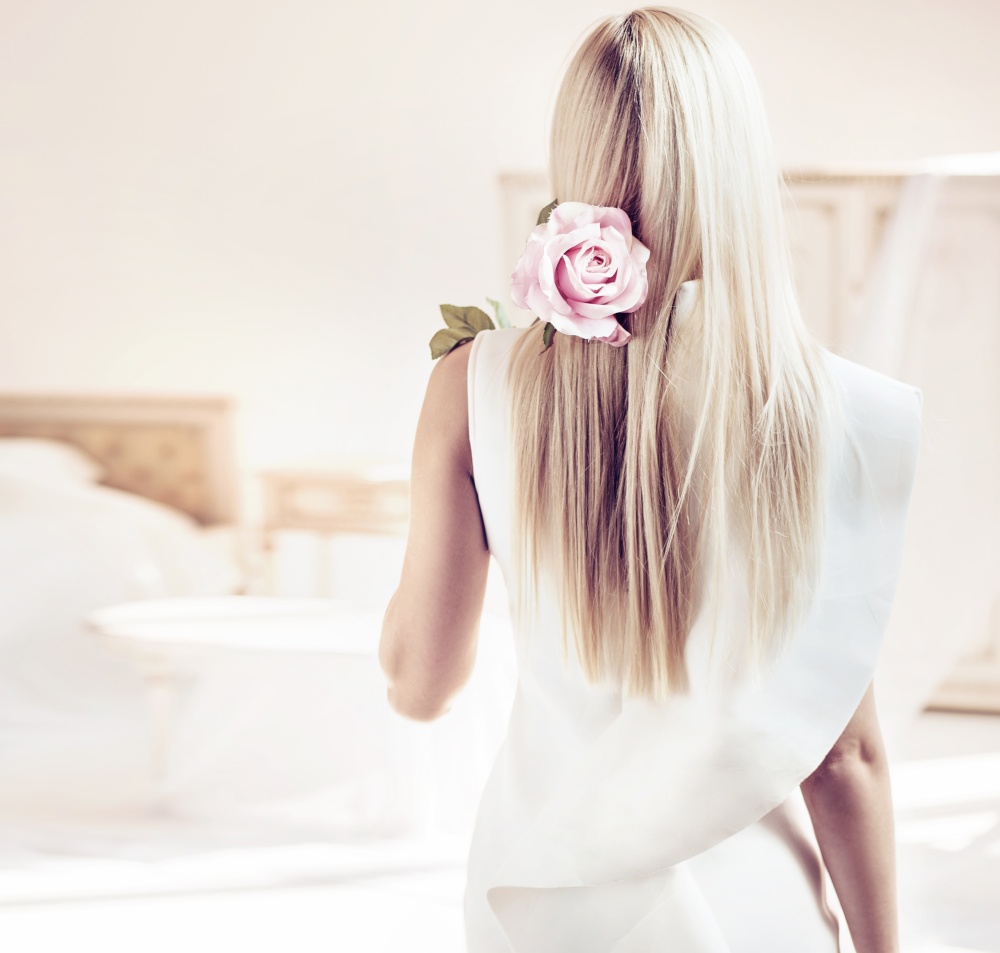 Backside portrait of a blond woman in a luxurious apartment