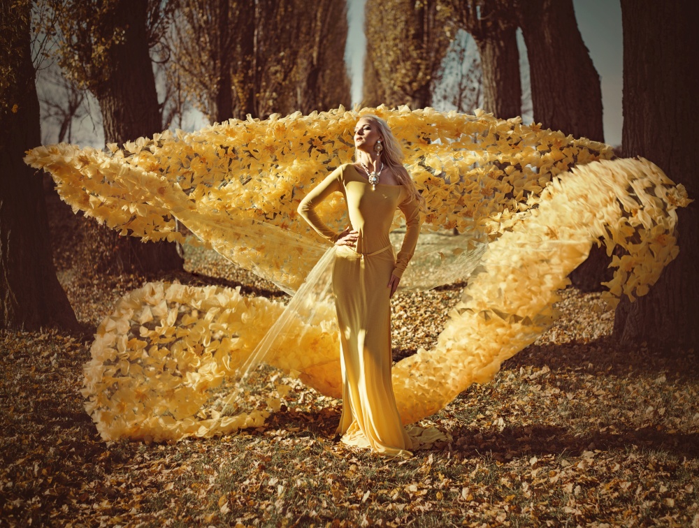 Portrait of a blond woman wearing a flowery, golden gown