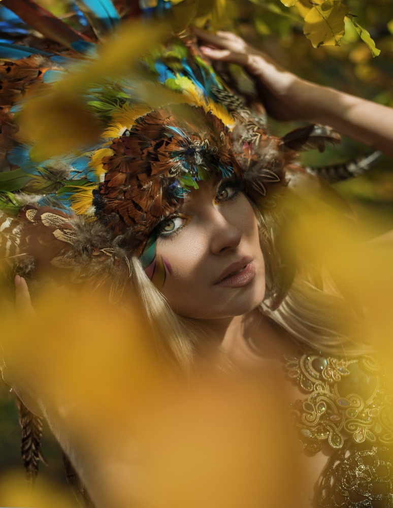 Art portrait of a blond nymph posing in the autumnal park