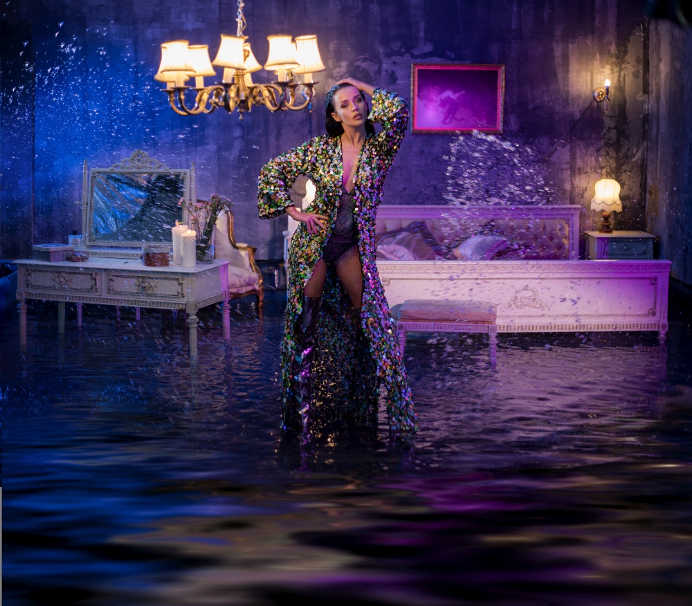 Portrait of a beautiful woman in a conceptual flooded apartment