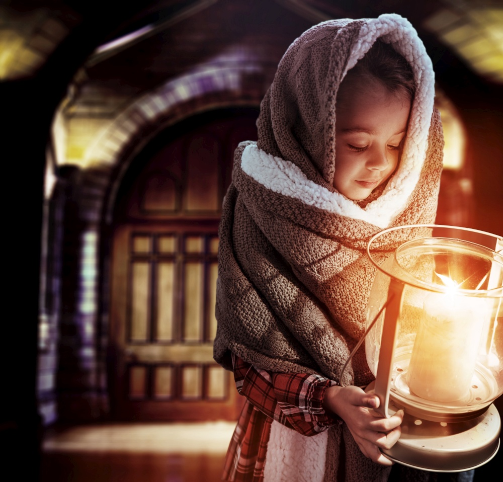 Conceptual portrait of a cute, little girl holding a torch