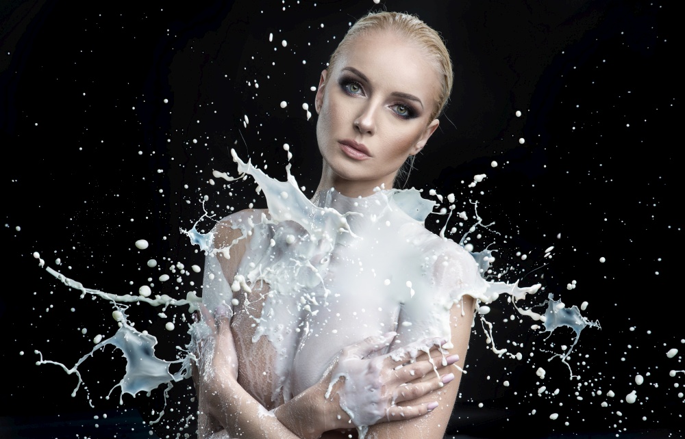 Huge splash of white paint on a young female body