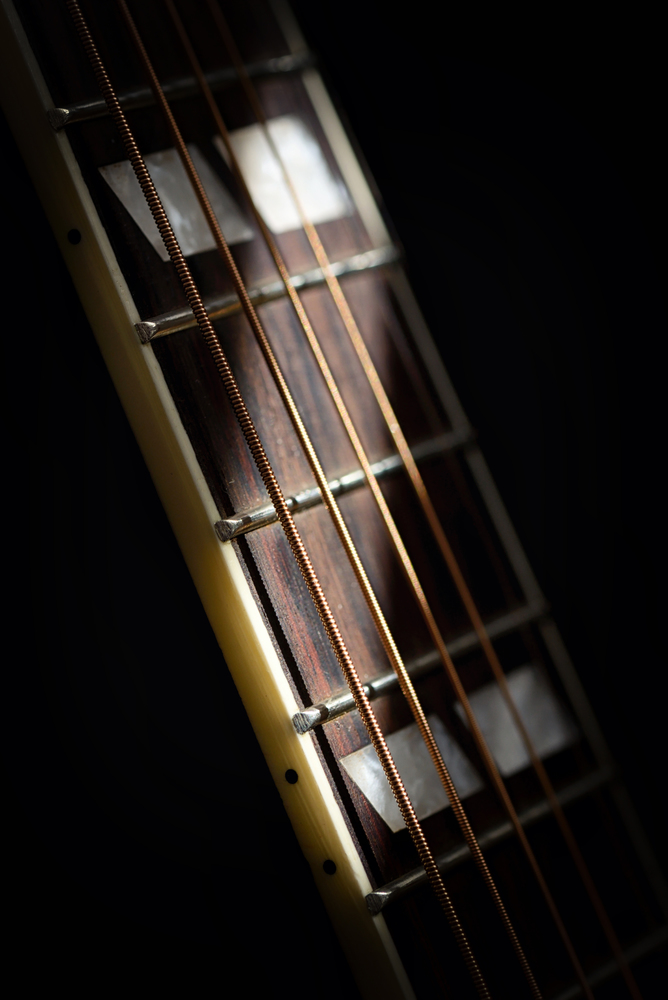 Guitar string details with shadows from daylight
