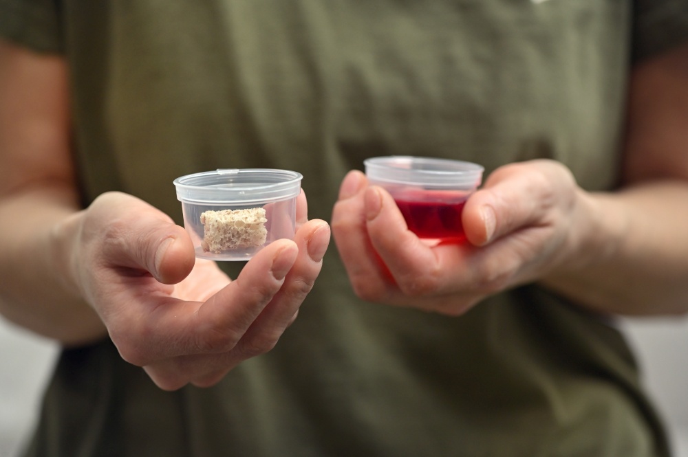 Woman Hands Takes Communion In One Time Use Containers To Protect From The Virus