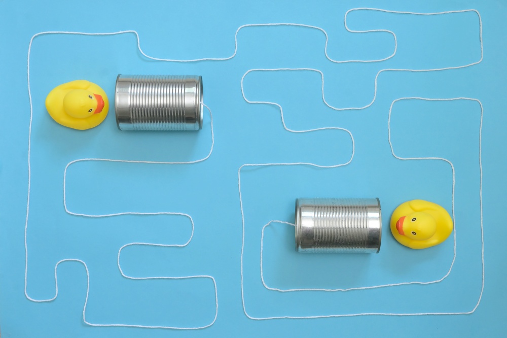 Abstract Communication Tin Can Phone With String and Yellow Toy Ducks