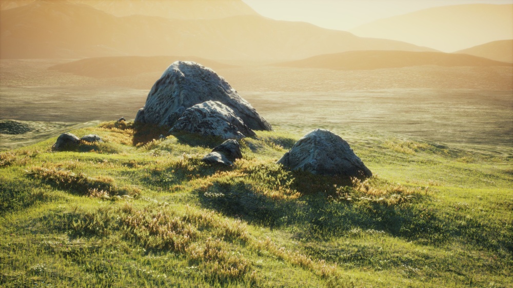 meadow with huge stones among the grass on the hillside at sunset