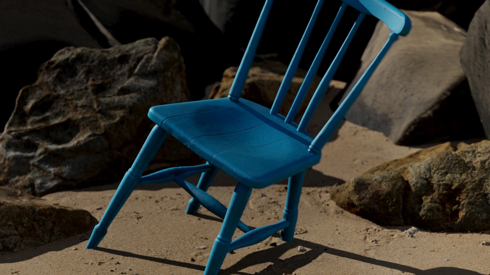 retro blue wooden chair on the beach