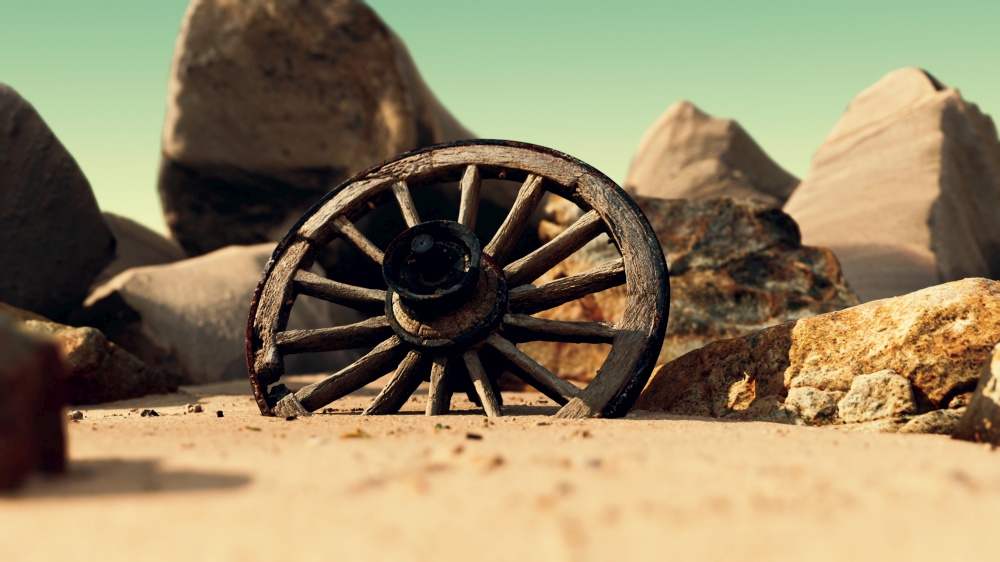old tradition waggon wheel on the sand