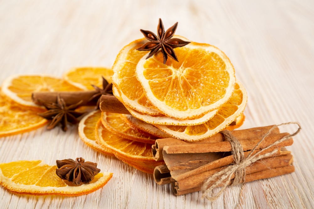 Dried orange slices, cinnamon and star anise on a wooden background. Spices for mulled wine and winter decoration.
