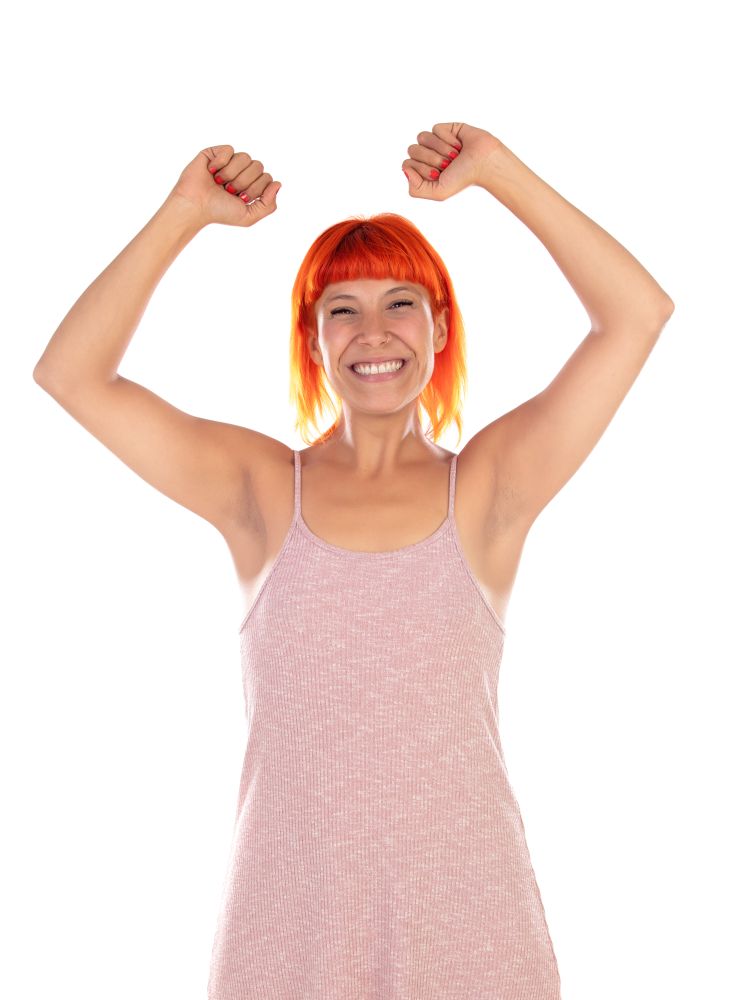 Winner woman with pink dress celebrating something isolated on a white background